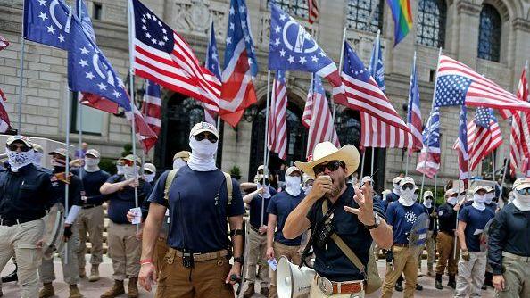 The Patriot Front make a speech as they march through a Boston Pride event 